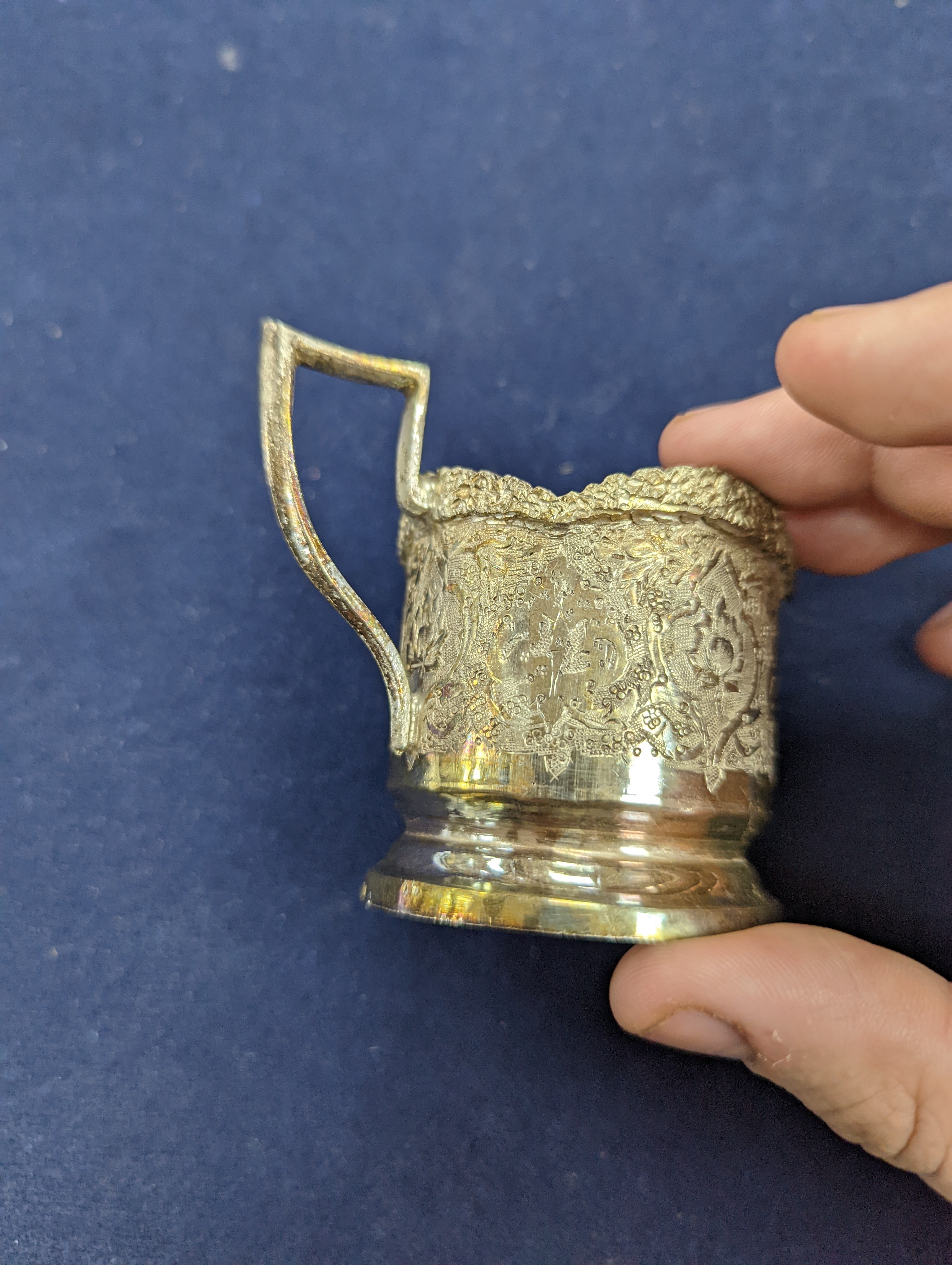 A set of six Persian embossed 84 standard white metal coffee cup holders and matching sugar bowl and cover by Vartan and four other Persian white metal items.